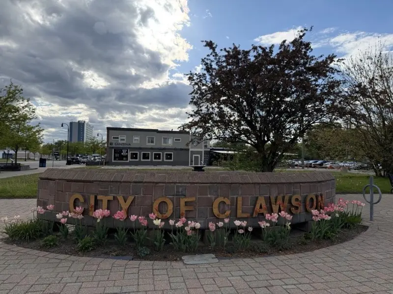 The City of Clawson monument sign and downtown, ringed with spring tulips